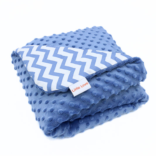 Blue Chevron car seat blanket for a 5-point harness, folded into a stack, blue minky side on top