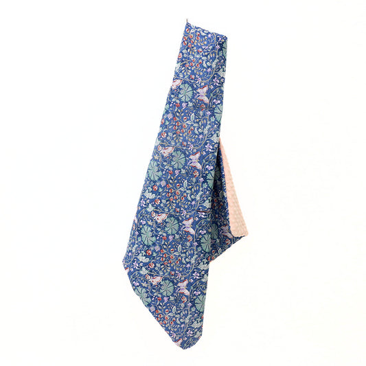 Navy and pink wild flower car seat blanket for a 5-point harness, hanging to show the patterned cotton and pink minky sides