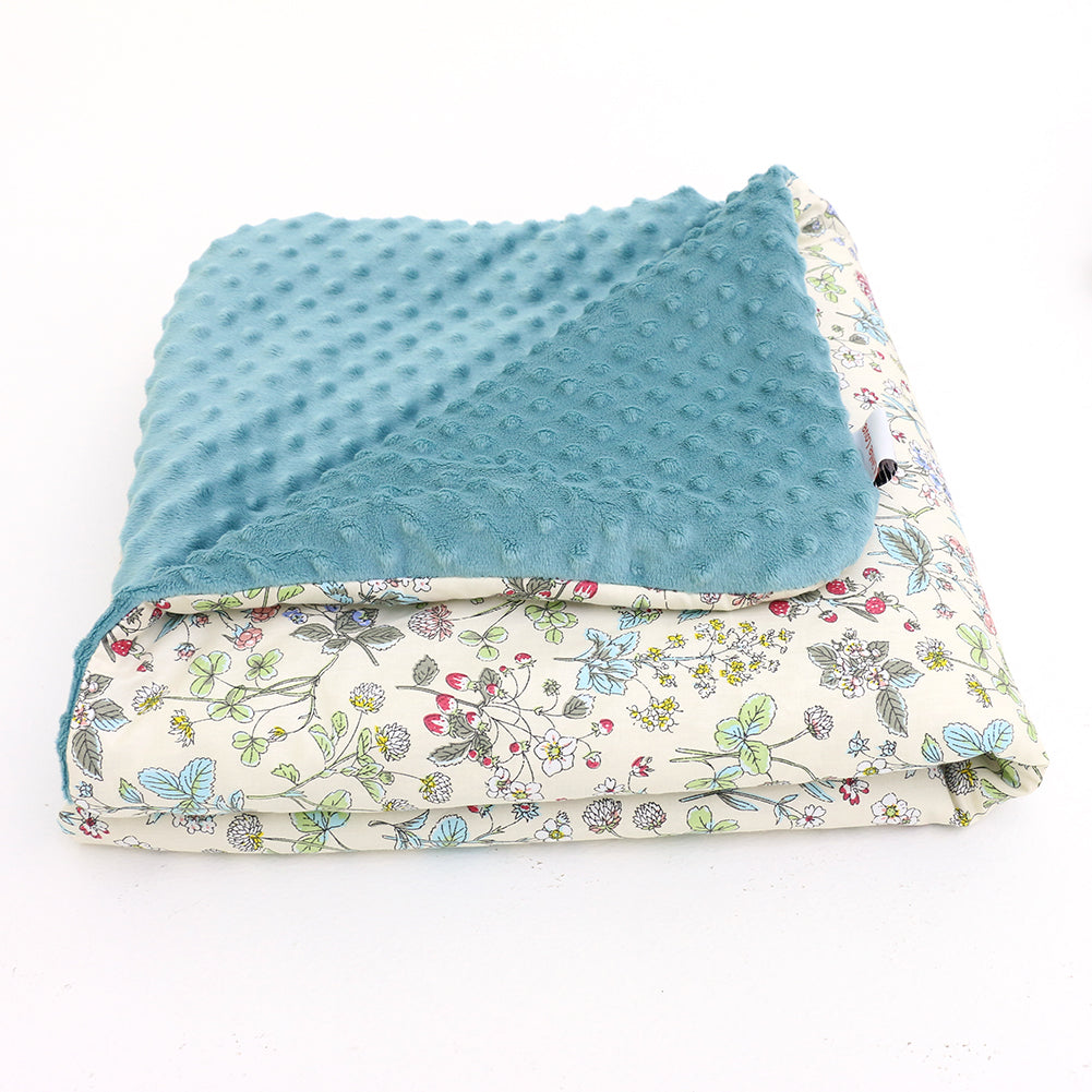 Wildflower car seat blanket for a 3-point harness, folded to show the patterned cotton and teal minky sides