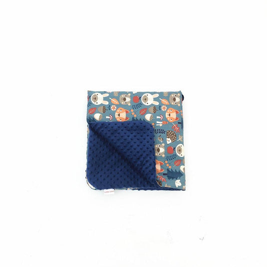 Forest Animals car seat blanket for a 5-point harness, folded to show the patterned cotton and navy minky sides