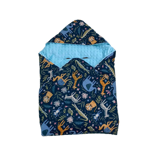 Blue Safari toddler blanket, patterned side out, folded with the light blue minky hood