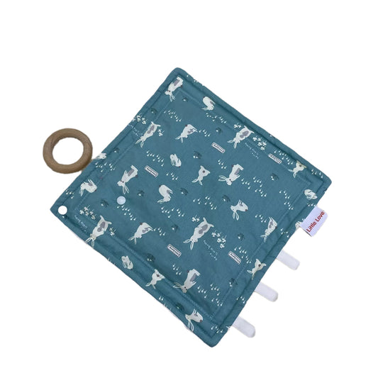 Teal Bunny taggie, patterned cotton side with ribbon tags and a wooden ring