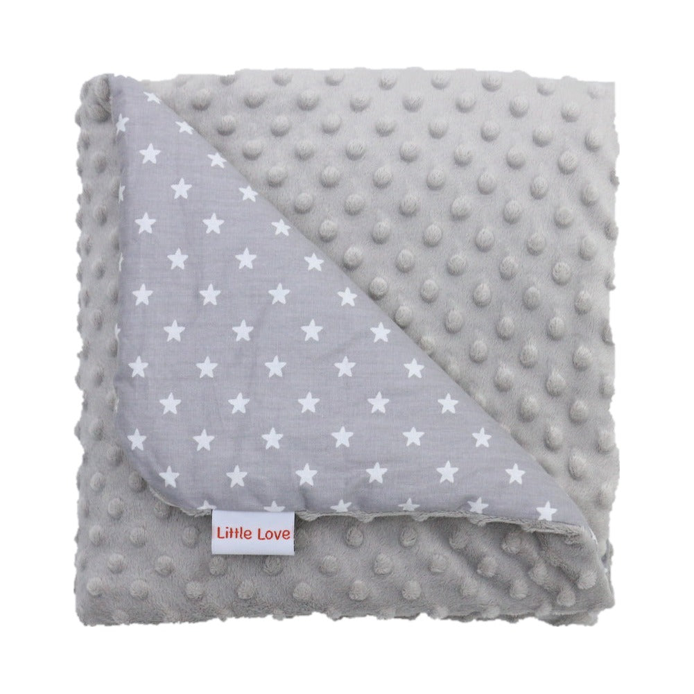 Grey Star infant snuggle blanket, folded to show the patterned cotton and grey minky sides