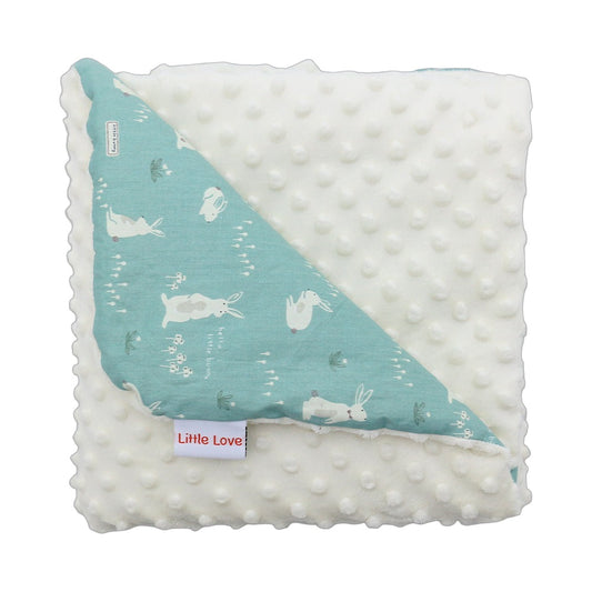 Teal Bunny infant snuggle blanket, folded to show the patterned cotton and cream minky sides