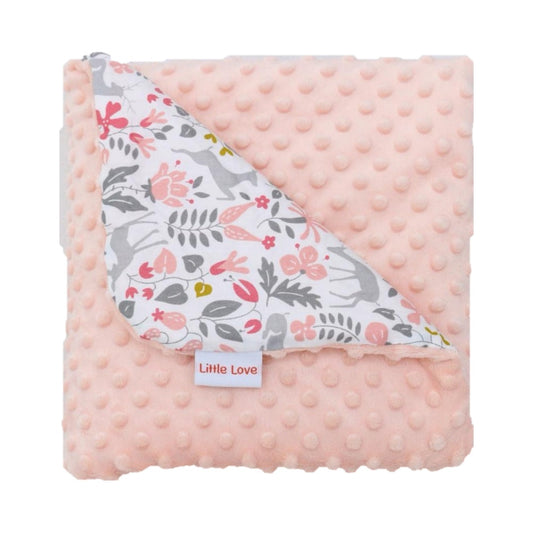 Little deer infant snuggle blanket, folded to show the patterned cotton and peach minky sides