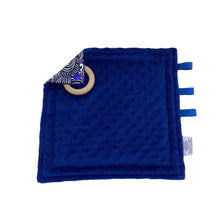 Load image into Gallery viewer, Waves taggie, navy minky side with ribbon tags and a wooden ring