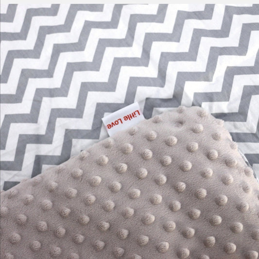 Grey chevron car seat blanket for a 5-point harness, close-up of the patterned cotton and grey minky fabrics