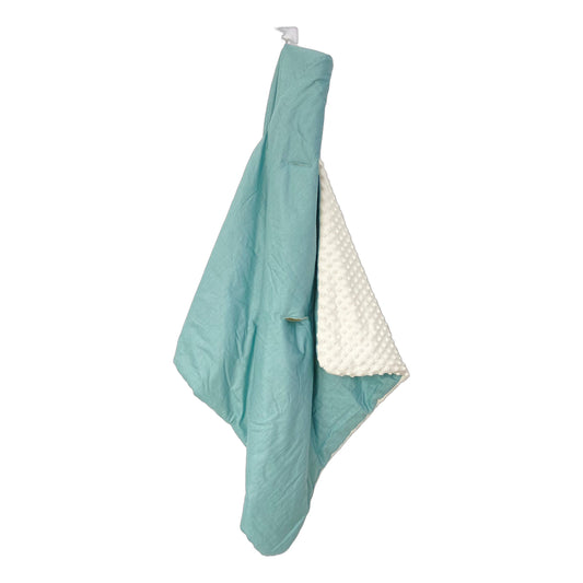 Teal Spot car seat blanket for a 3-point harness, hanging to show the patterned cotton and cream minky sides
