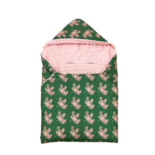 Pink Tractor car seat blanket for a 5-point harness, patterned side out, folded with the pink minky hood