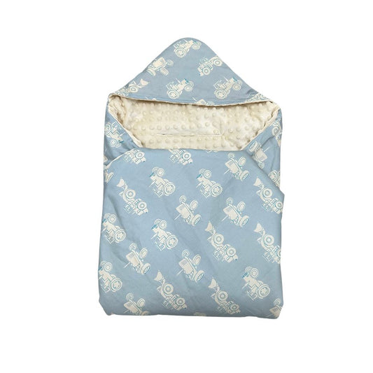 Blue Tractor car seat blanket, patterned side out, folded with the cream minky hood
