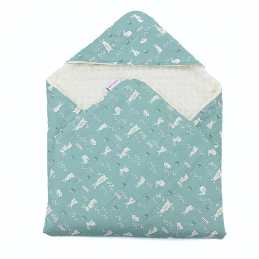 Teal Bunnies car seat blanket for a 3-point harness, patterned side out, folded with the cream minky hood