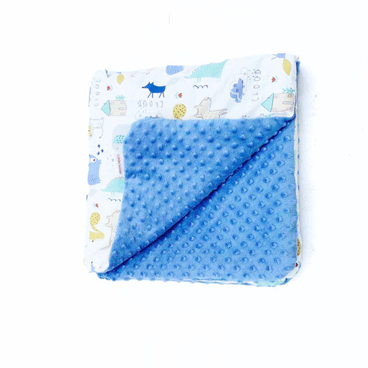 The Wild One car seat blanket for a 5-point harness, folded to show the patterned cotton and blue minky sides