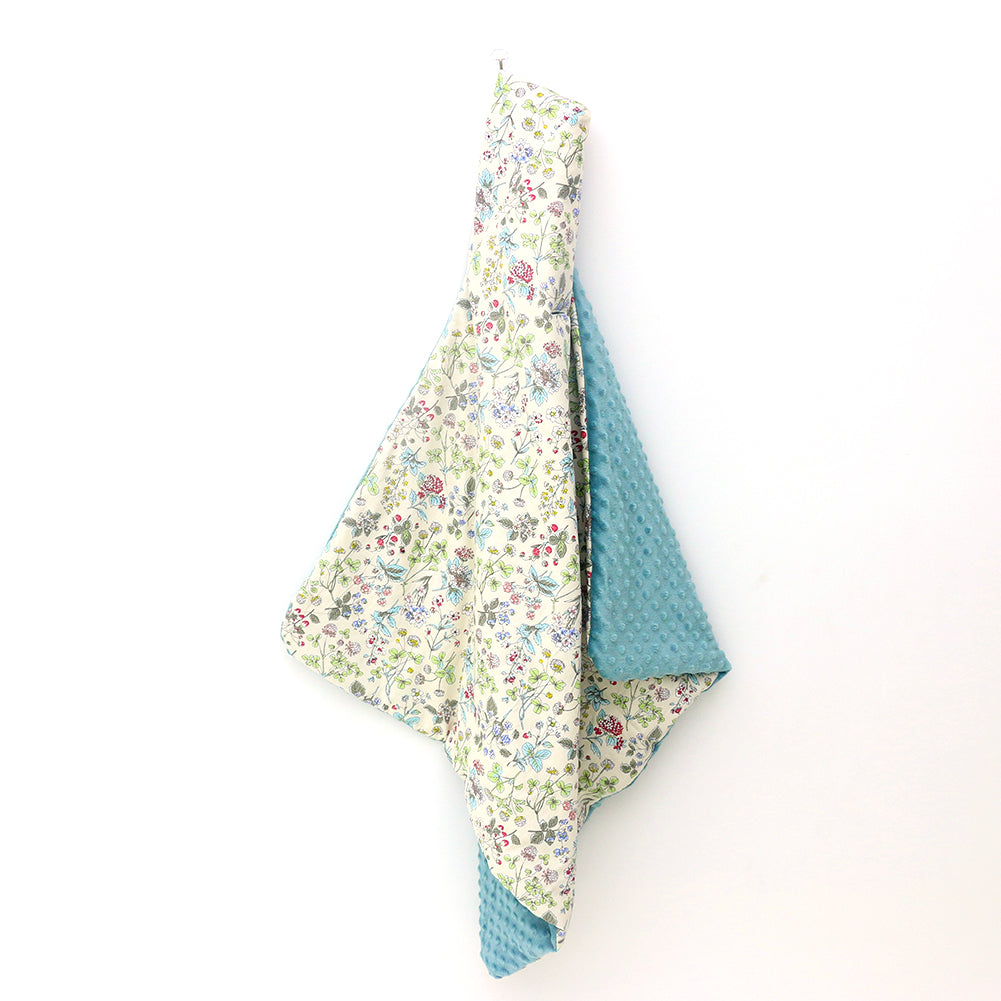 Wildflower car seat blanket for a 3-point harness, hanging to show the patterned cotton and teal minky sides