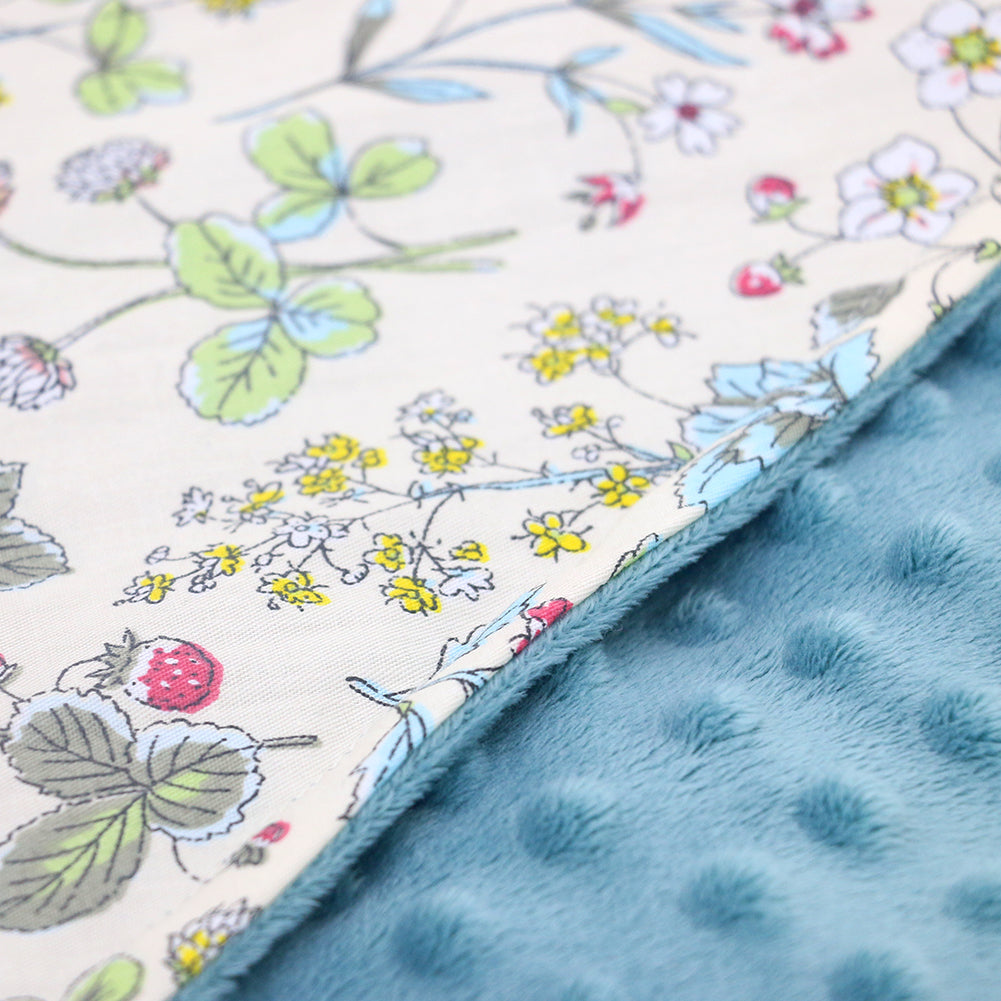 Wildflower car seat blanket for a 3-point harness, close-up of the patterned cotton and teal minky fabrics