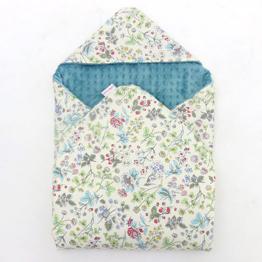 Wildflower toddler blanket, patterned side out, folded with the teal minky hood
