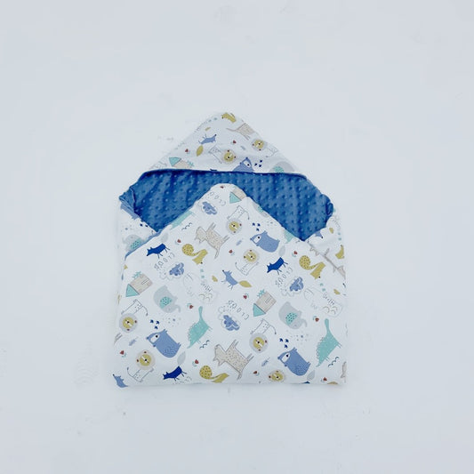 The Wild One car seat blanket for a 3-point harness, patterned side out, folded with the blue minky hood