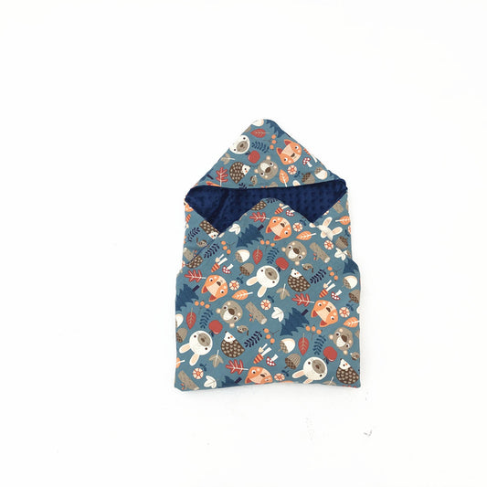 Forest Animals car seat blanket for a 3-point harness, patterned side out, folded with the navy minky hood