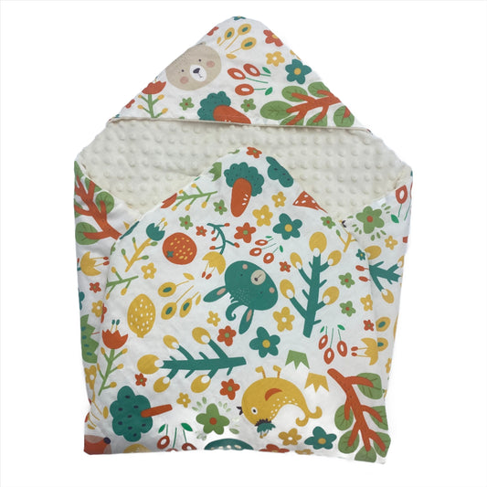 Jack car seat blanket for a 3-point harness, patterned side out, folded with the cream minky hood