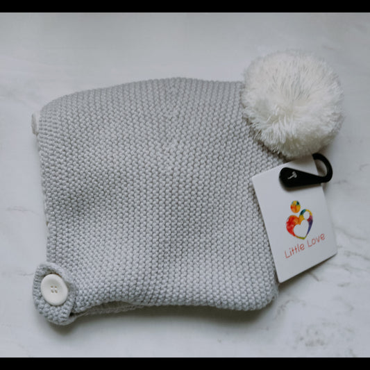 Pale Grey hat, knitted bonnet with a pom-pom and button strap, with its Little Love tag